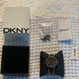 DKNY watch with original storage box, extra links and instructions.